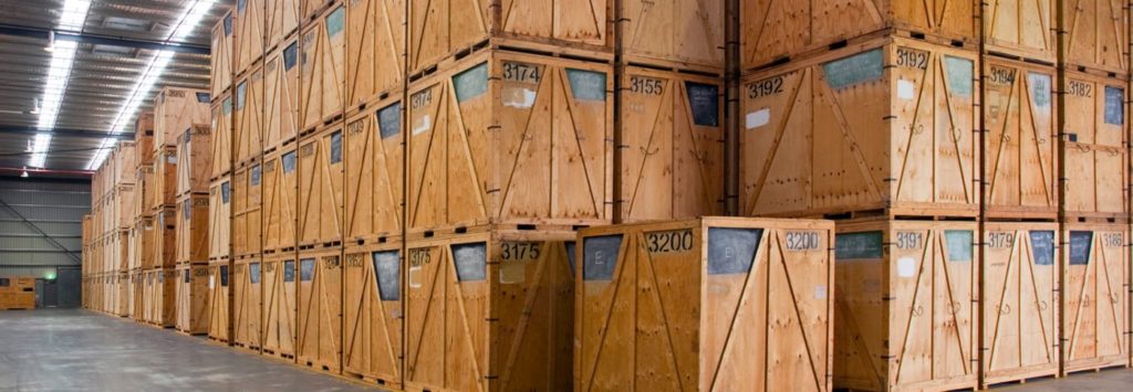 wood shipping crates in long warehouse